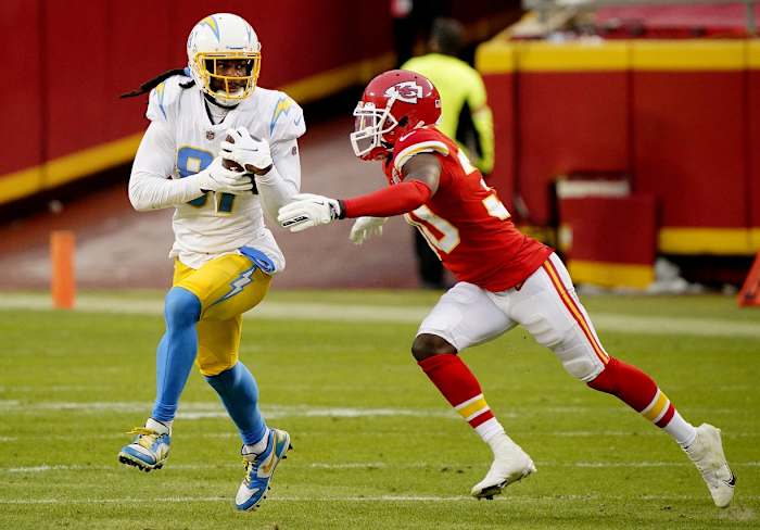 Jan 3, 2021; Kansas City, Missouri, USA; Los Angeles Chargers wide receiver Mike Williams (81) catches a pass against Kansas City Chiefs cornerback Deandre Baker (30) during the first half at Arrowhead Stadium. Mandatory Credit: Jay Biggerstaff-USA TODAY Sports